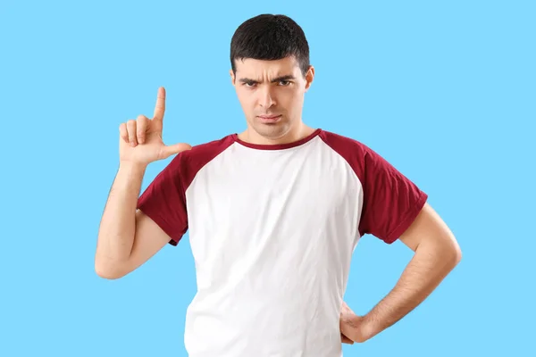 Upset Young Man Showing Loser Gesture Blue Background — Stock Photo, Image