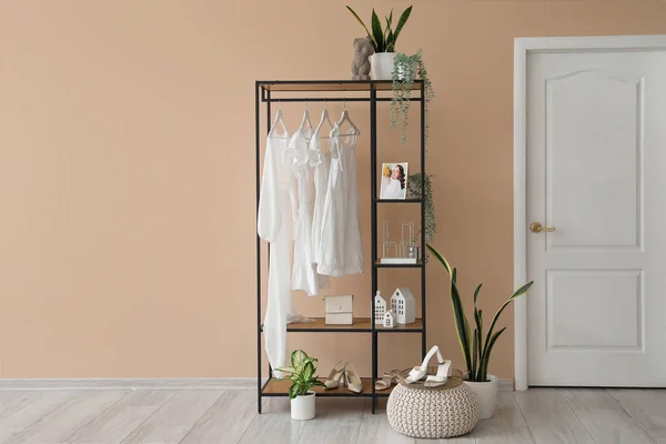 Shelving Unit Clothes Accessories Houseplants Beige Wall — Stock Photo, Image