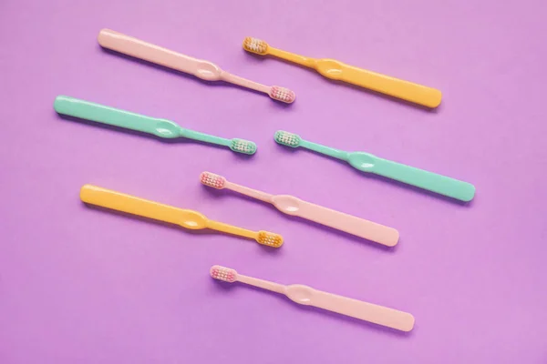 Many Plastic Toothbrushes Purple Background — Stock Photo, Image