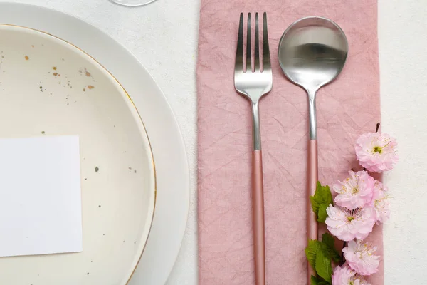 stock image Beautiful table serving with cutlery, blooming tree branch and blank invitation card white background