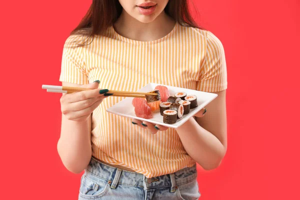 Young Woman Sushi Rolls Chopsticks Red Background Closeup — Stock Photo, Image