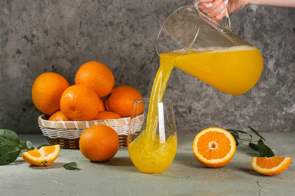 Woman Pouring Fresh Orange Juice Jug Glass Grey Background — Stock Photo, Image