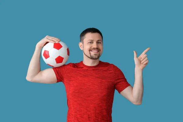 Happy Man Soccer Ball Pointing Something Blue Background — Stock Photo, Image