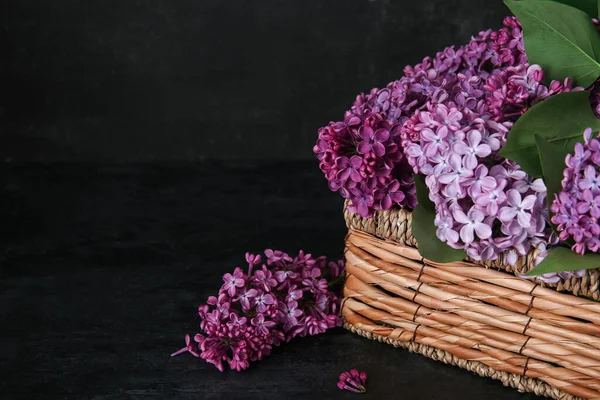 Wicker Box Beautiful Lilac Flowers Black Table — Stock Photo, Image