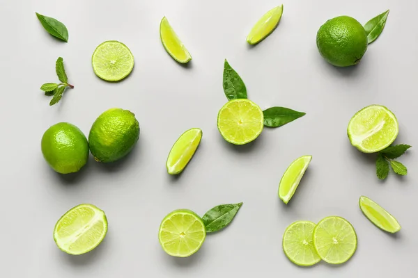 Slices Fresh Lime Leaves Grey Background — Stock Photo, Image