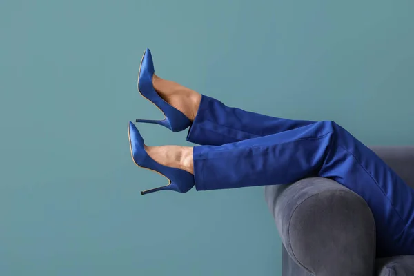 Female Legs High Heels Sofa Blue Background — Stock Photo, Image