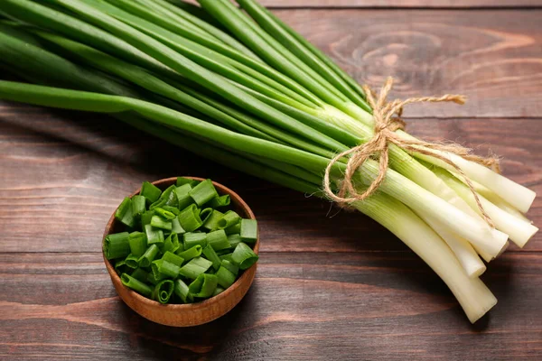 Bunch Fresh Green Onion Bowl Cut Pieces Wooden Background — Stock Photo, Image