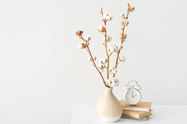 Cotton Sprigs Vase Books Alarm Clock Table White Wall — Stock Photo, Image