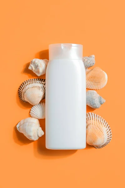 Bottle Sunscreen Cream Seashells Orange Background — Stock Photo, Image
