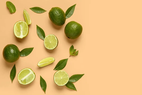 Slices Fresh Lime Leaves Orange Background — Stock Photo, Image