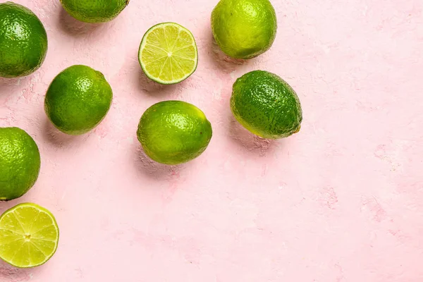 stock image Fresh limes on pink background