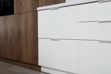 Modern mutfakta çekmeceleri olan beyaz tezgâhlar.