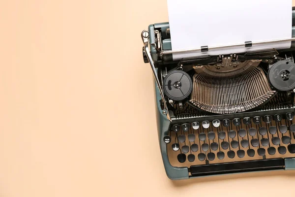 stock image Vintage typewriter with blank paper sheet on beige background