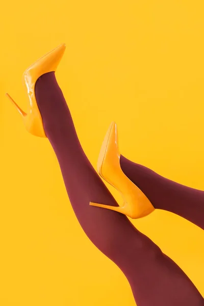 Женские Ноги Черных Колготках Высоких Каблуках Желтом Фоне — стоковое фото