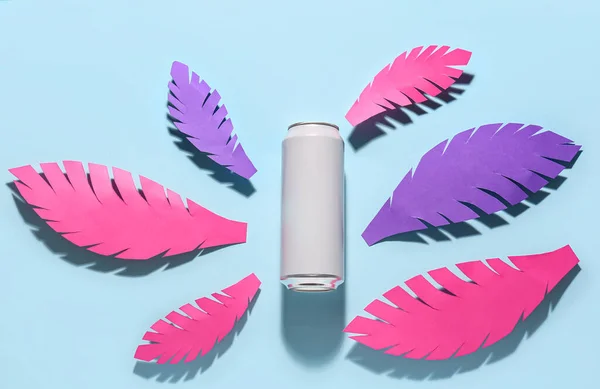 stock image Composition with can of fresh soda and paper leaves on blue background