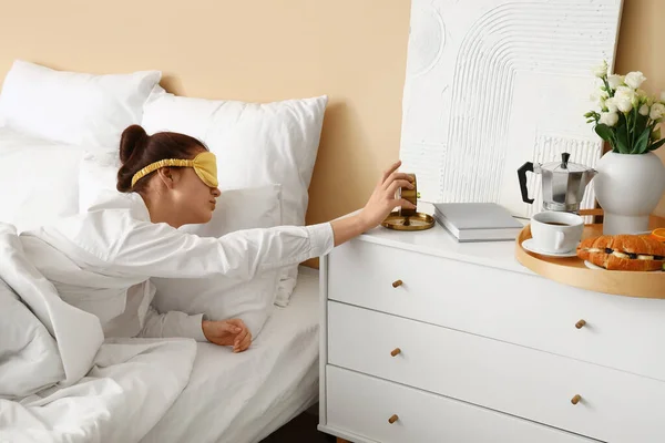 stock image Morning of young woman turning off alarm clock in bedroom