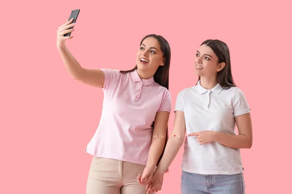 Female Blood Donors Applied Patches Taking Selfie Pink Background — Stock Photo, Image