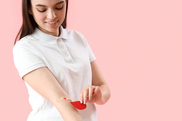 Donatrice Con Cerotto Medico Applicato Goccia Sangue Carta Sfondo Rosa — Foto Stock