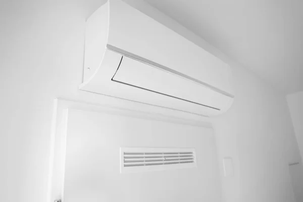 部屋の光壁に掛けられたモダンなエアコン — ストック写真