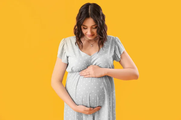 stock image Young pregnant woman on yellow background