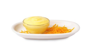 Lezzetli çedar soslu tabak ve beyaz arka planda rendelenmiş peynir.