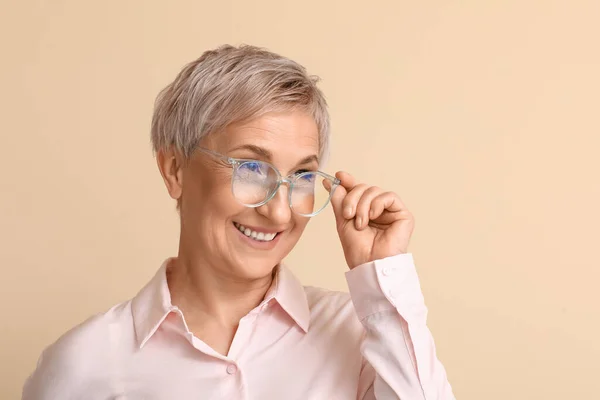 Mature Blonde Woman Eyeglasses Beige Background Closeup — Stock Photo, Image