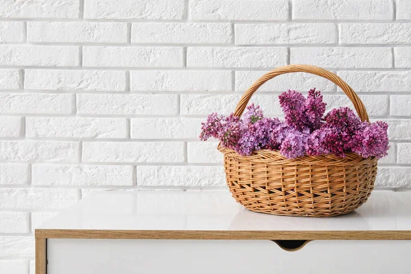 Košík Krásnými Šeříkové Květy Hrudi Zásuvky Blízkosti Světlé Cihlové Zdi — Stock fotografie