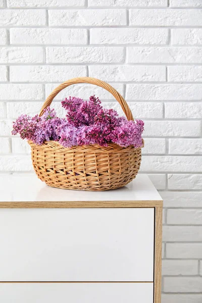 Panier Avec Belles Fleurs Lilas Sur Commode Près Mur Briques — Photo