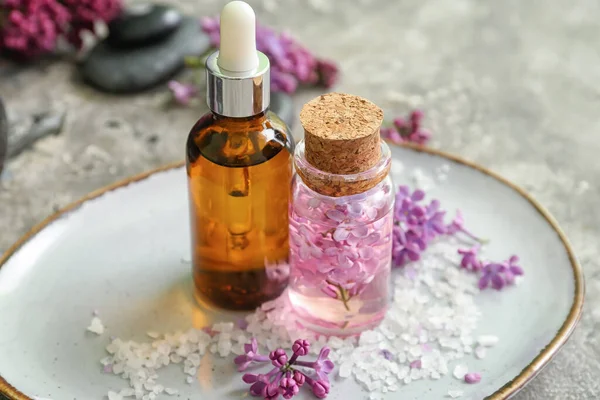 Bottles Cosmetic Oil Beautiful Lilac Flowers Sea Salt Grey Table — Stock Photo, Image