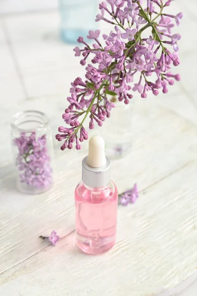 Bottles Cosmetic Oil Beautiful Lilac Flowers White Table — Stock Photo, Image