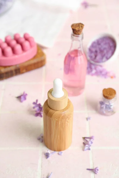 Bottles Cosmetic Oil Beautiful Lilac Flowers Sea Salt Pink Tile — Stock Photo, Image