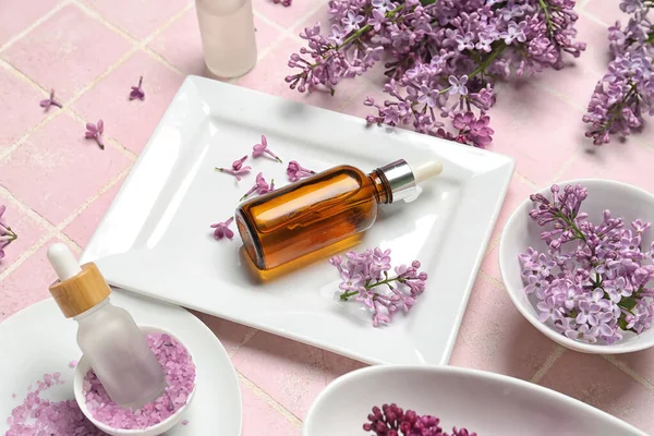 Bottles Lilac Essential Oil Sea Salt Flowers Pink Background Closeup — Stock Photo, Image