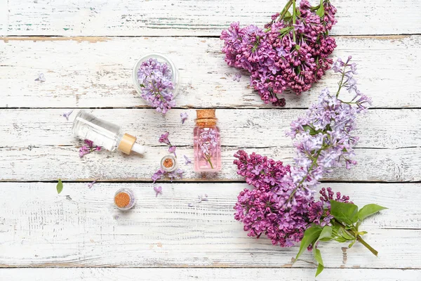 Composition Bottles Lilac Essential Oil Flowers Light Wooden Background — Stock Photo, Image