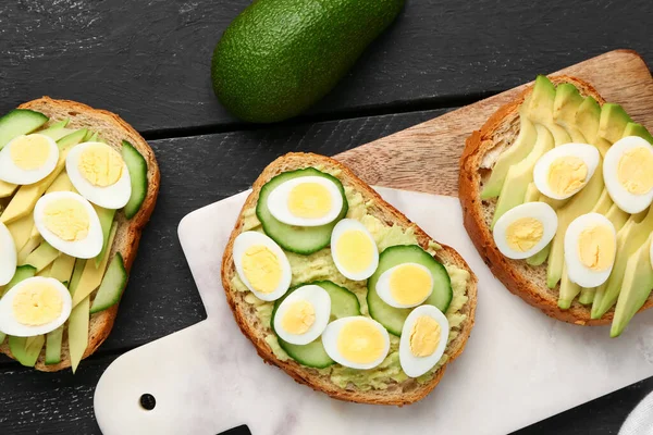 Tasty Toasts Quail Eggs Avocado Cucumber Dark Wooden Background — Stock Photo, Image