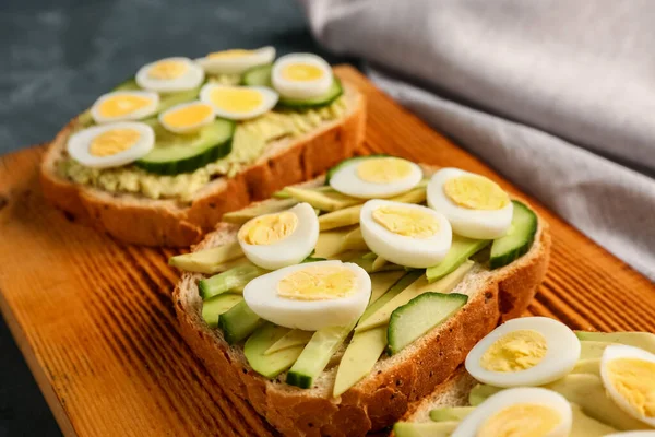 Tasty Toasts Quail Eggs Avocado Cucumber Dark Background Closeup — Stock Photo, Image