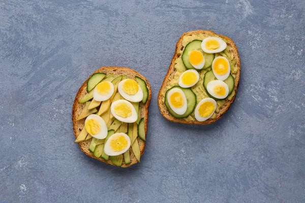 Tasty Toasts Quail Eggs Avocado Cucumber Blue Background — Stock Photo, Image