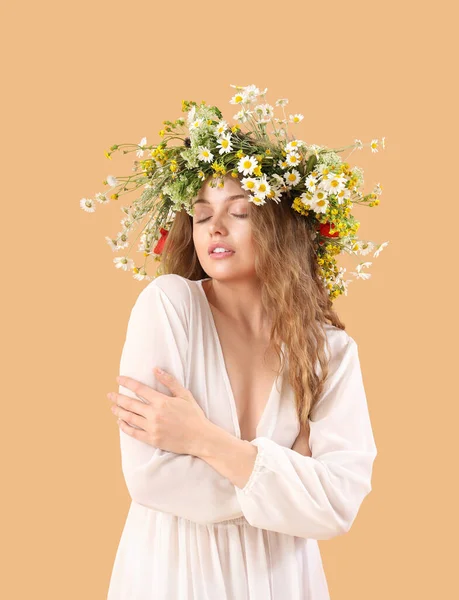ベージュの背景に花の花輪の美しい若い女性 — ストック写真