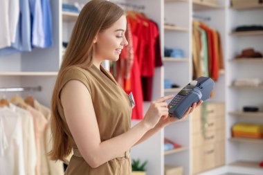 Butikte ödeme terminali olan kadın satıcı