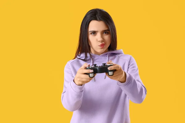 Emotional Young Woman Playing Video Game Yellow Background — Stock Photo, Image