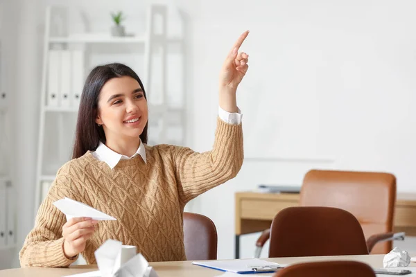 Young Woman Paper Plane Pointing Something Office — Stock Photo, Image