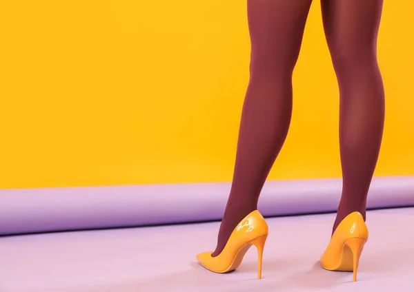 Kobiece Nogi Czarnych Rajstopach Żółte Szpilki Tle Koloru Widok Tyłu — Zdjęcie stockowe