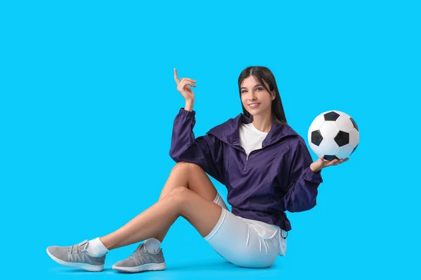 Νεαρή Γυναίκα Μπάλα Ποδοσφαίρου Μπλε Φόντο — Φωτογραφία Αρχείου