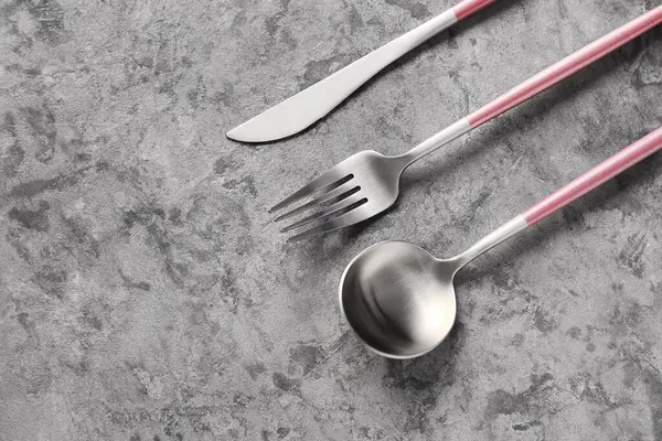 Stainless Steel Cutlery Pink Handles Grey Background — Stock Photo, Image