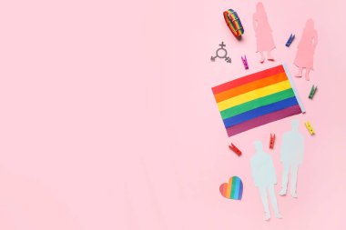 Pembe arka planda kağıt insan figürleri ve sembolleri olan LGBT bayrağı