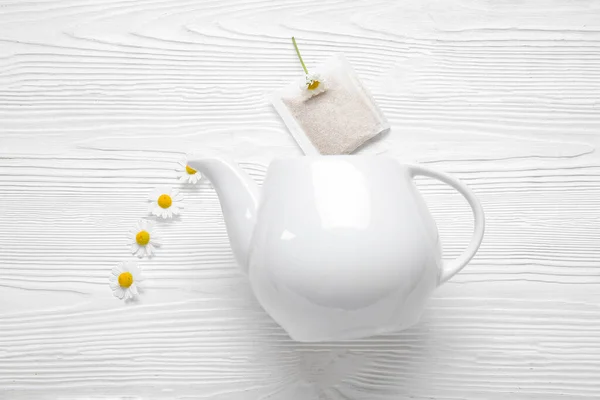 Composition Teapot Tea Bag Chamomile Flowers Light Wooden Background — Stock Photo, Image