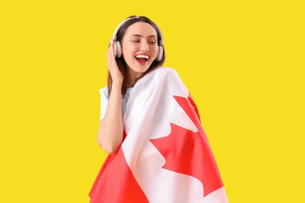 Young Woman Headphones Flag Canada Yellow Background — Stock Photo, Image