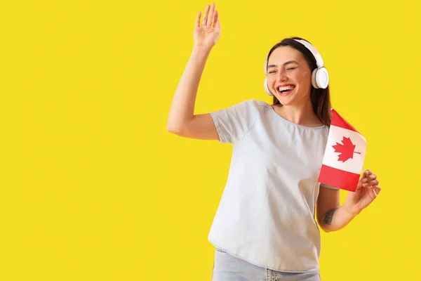 Young Woman Headphones Flag Canada Yellow Background — Stock Photo, Image