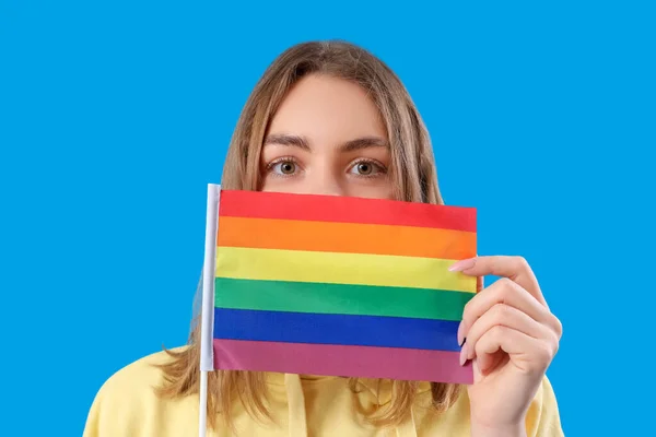 青色の背景にLgbtの旗を持つ若い女性 クローズアップ — ストック写真