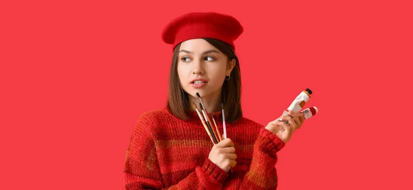 Young Female Artist Paints Brushes Red Background — Stock Photo, Image