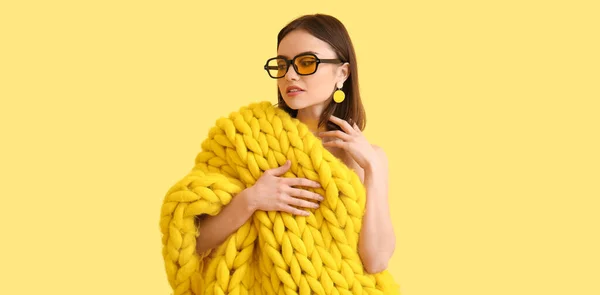 头戴浅黄背景太阳镜 头戴针织格子布的时髦年轻女子 — 图库照片